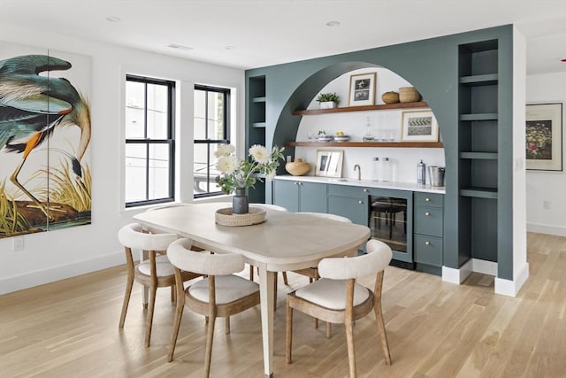 361 Walden Unit 361, Cambridge, MA 02138 - dining area featuring wine cooler, built in features, bar with sink, and light wood-type flooring