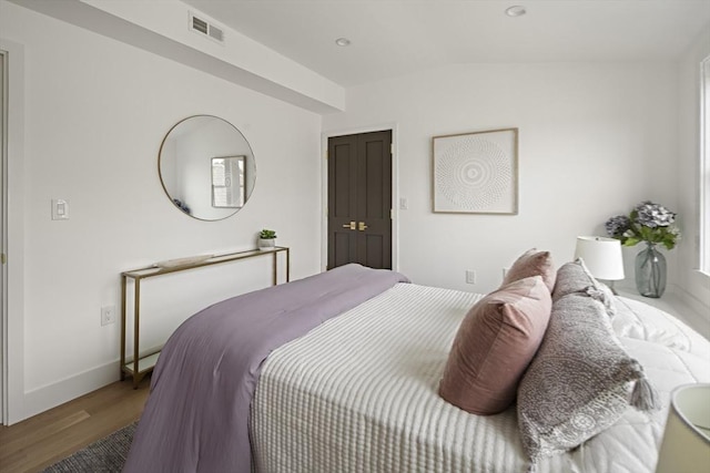 361 Walden Unit 361, Cambridge, MA 02138 - bedroom featuring vaulted ceiling and wood finished floors