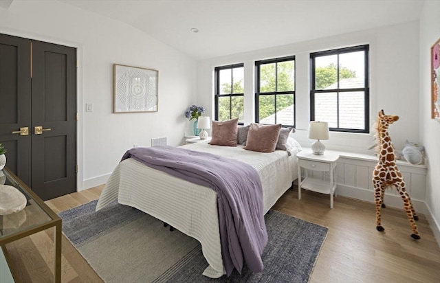 361 Walden Unit 361, Cambridge, MA 02138 - bedroom with lofted ceiling and light wood-style floors