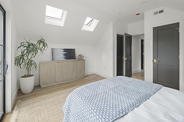 361 Walden Unit 361, Cambridge, MA 02138 - bedroom featuring a skylight, vaulted ceiling, and light wood finished floors