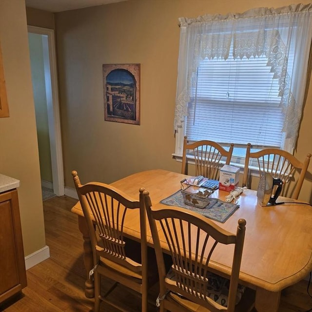 dining area with wood finished floors and baseboards