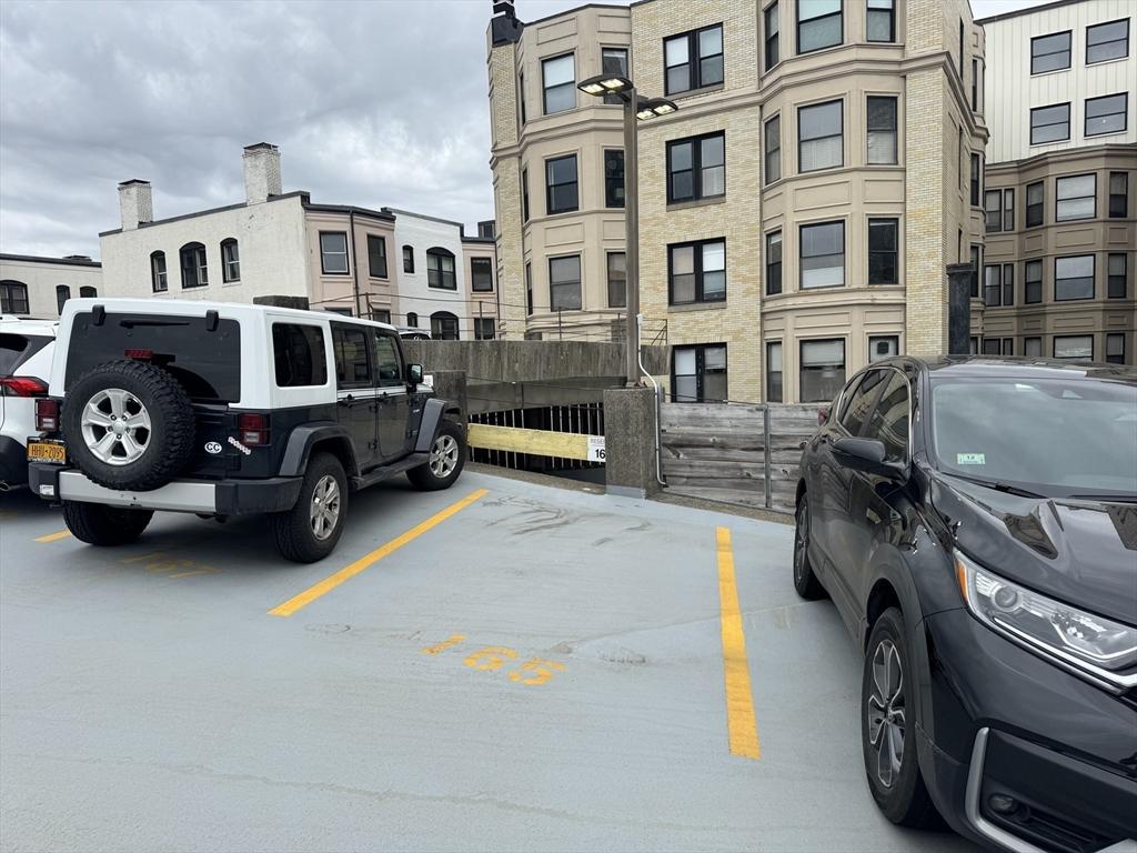 uncovered parking lot featuring fence