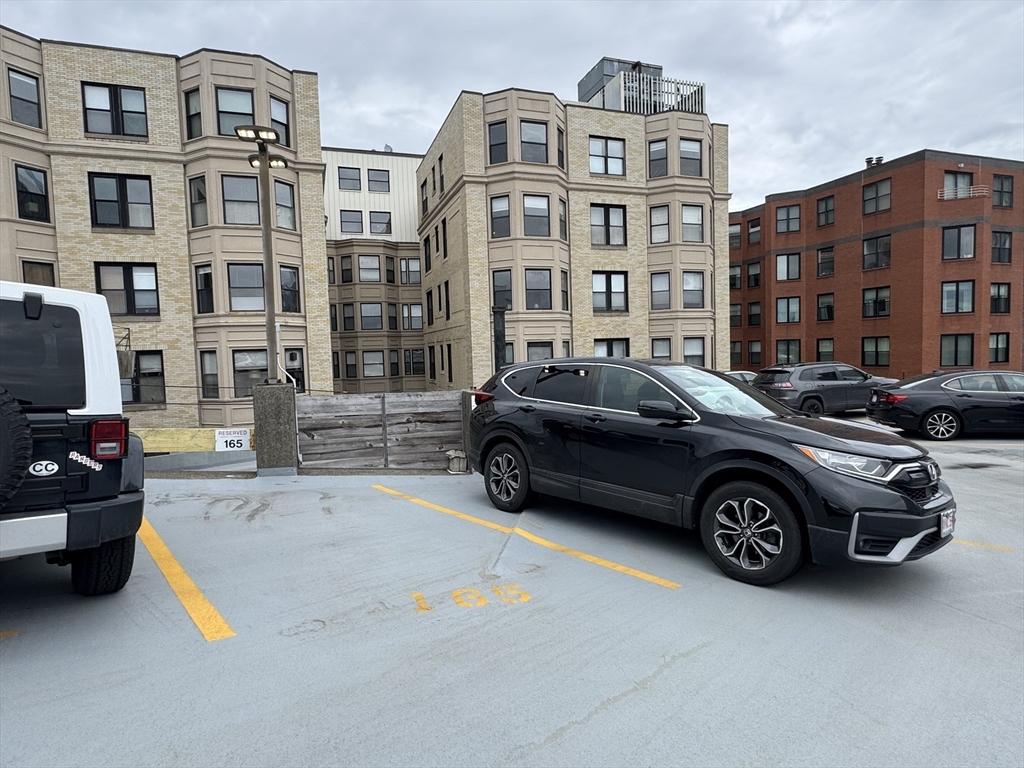 view of building exterior featuring uncovered parking