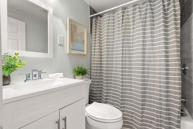 full bathroom with toilet and vanity