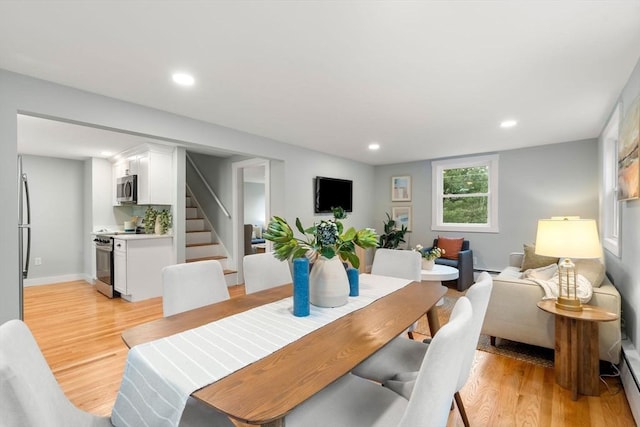 dining area featuring recessed lighting, baseboards, stairs, and light wood finished floors