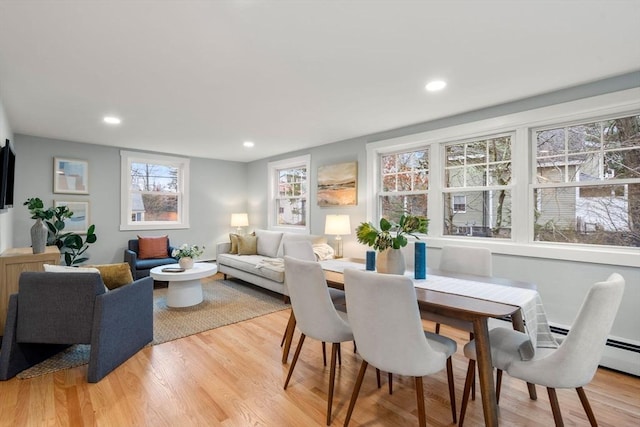 dining space with recessed lighting and light wood-type flooring