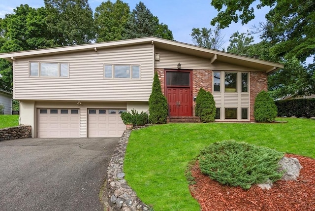 view of front of property with a garage and a front yard