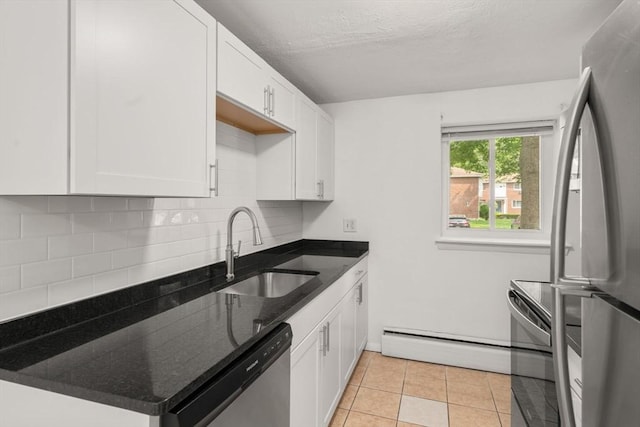 172 Bishop Dr Unit 172, Framingham, MA 01702 - kitchen with stainless steel appliances, a sink, a baseboard radiator, tasteful backsplash, and a textured ceiling