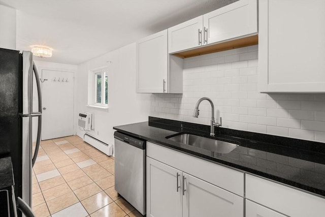 172 Bishop Dr Unit 172, Framingham, MA 01702 - kitchen with appliances with stainless steel finishes, baseboard heating, a sink, backsplash, and white cabinets