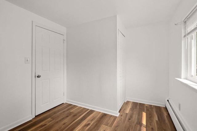 172 Bishop Dr Unit 172, Framingham, MA 01702 - walk in closet featuring a baseboard radiator and dark wood-style floors