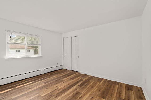 172 Bishop Dr Unit 172, Framingham, MA 01702 - spare room featuring wood finished floors, baseboard heating, and baseboards