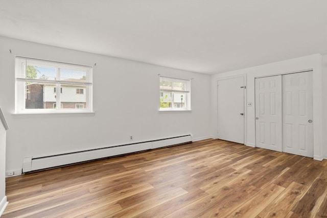 172 Bishop Dr Unit 172, Framingham, MA 01702 - unfurnished bedroom with baseboard heating and light wood-style flooring