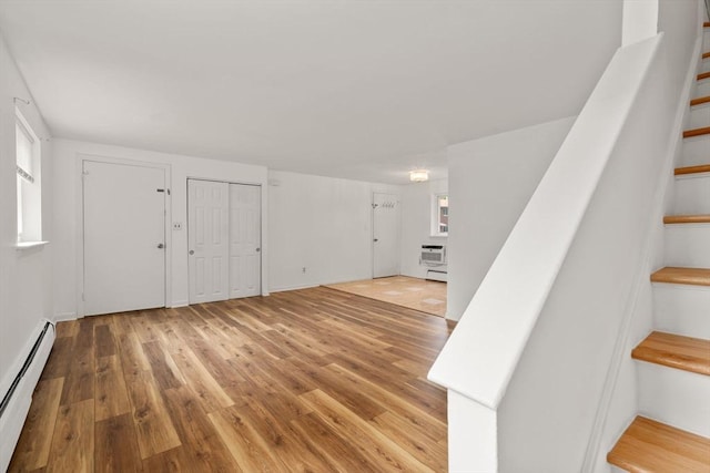 172 Bishop Dr Unit 172, Framingham, MA 01702 - entryway featuring a baseboard radiator, stairway, and wood finished floors