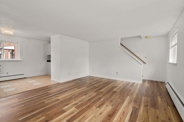172 Bishop Dr Unit 172, Framingham, MA 01702 - unfurnished living room with baseboard heating and wood finished floors