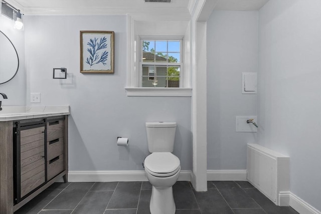 8 Piedmont St, Methuen, MA 01844 - half bath featuring toilet, tile patterned floors, vanity, baseboards, and ornamental molding