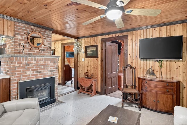 137 Rock Harbor Rd Unit 4, Orleans, MA 02653 - living room with wooden walls, light tile patterned floors, wooden ceiling, a fireplace, and a ceiling fan