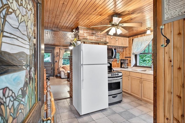 137 Rock Harbor Rd Unit 4, Orleans, MA 02653 - kitchen with freestanding refrigerator, stainless steel gas stove, wood ceiling, black microwave, and light brown cabinetry