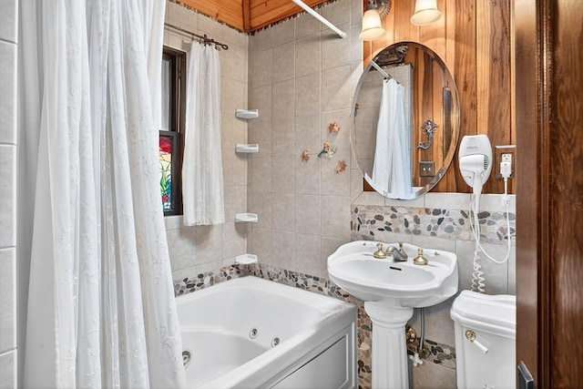 137 Rock Harbor Rd Unit 4, Orleans, MA 02653 - bathroom with tile walls, a combined bath / shower with jetted tub, and backsplash