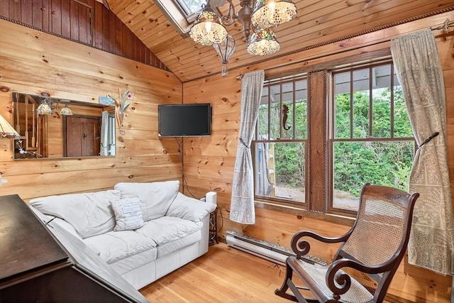 137 Rock Harbor Rd Unit 4, Orleans, MA 02653 - living room with vaulted ceiling, healthy amount of natural light, wood walls, wooden ceiling, and a chandelier