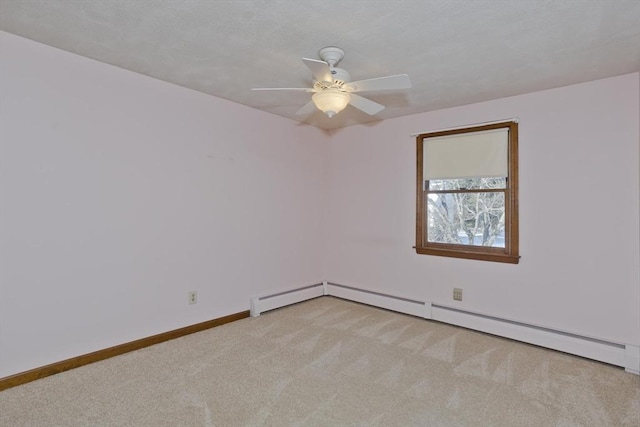 carpeted empty room featuring ceiling fan and a baseboard heating unit