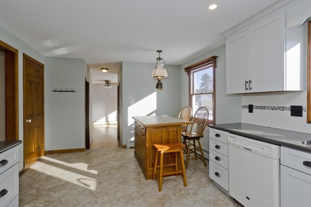 kitchen featuring white cabinetry, decorative light fixtures, a baseboard radiator, white dishwasher, and decorative backsplash