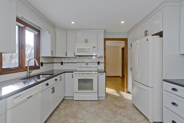 kitchen with white cabinetry, white appliances, sink, and backsplash