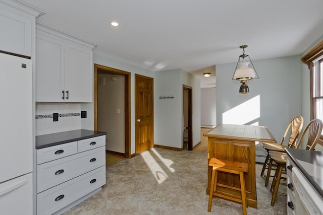 kitchen with white cabinetry, fridge, dishwasher, pendant lighting, and backsplash