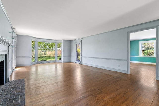 38 Bullard St, Sherborn, MA 01770 - unfurnished living room with a fireplace, hardwood / wood-style floors, and baseboards