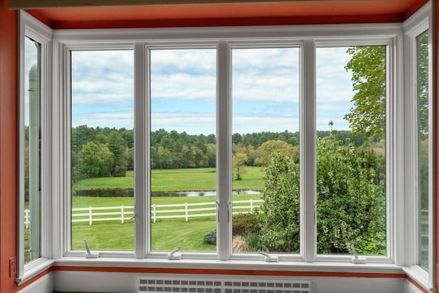 38 Bullard St, Sherborn, MA 01770 - unfurnished sunroom with a water view, radiator, and view of scattered trees
