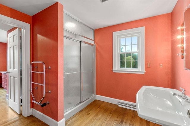 38 Bullard St, Sherborn, MA 01770 - bathroom featuring a sink, wood finished floors, baseboards, and a shower stall