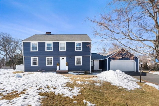 colonial house with an attached garage and driveway