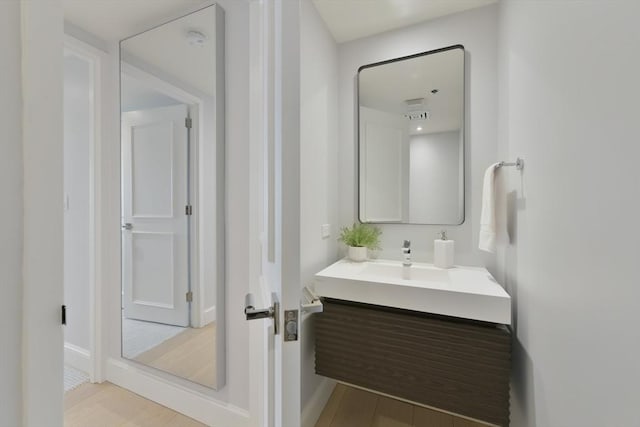 bathroom with vanity and hardwood / wood-style floors