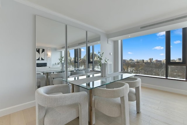 dining space with light hardwood / wood-style flooring