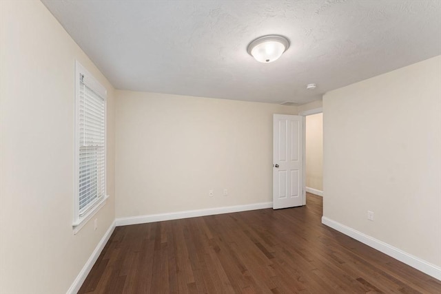 11 Winslow Way, Swansea, MA 02777 - unfurnished room with dark wood finished floors, baseboards, a smoke detector, and a textured ceiling