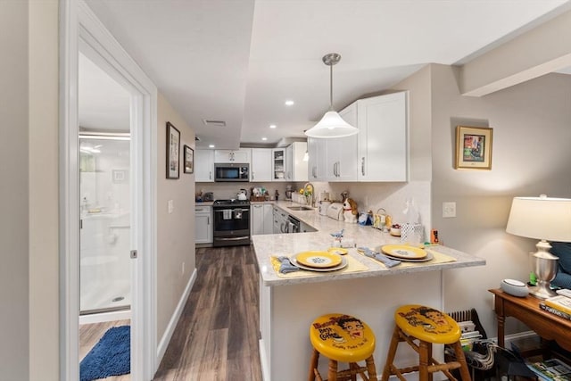 11 Winslow Way, Swansea, MA 02777 - kitchen featuring stainless steel appliances, a sink, dark wood-style floors, a peninsula, and white cabinets