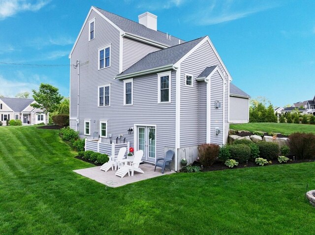 11 Winslow Way, Swansea, MA 02777 - rear view of house with a patio, a yard, a chimney, and a shingled roof