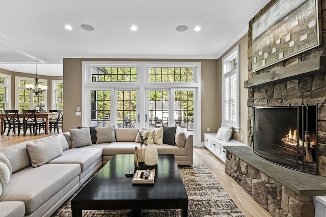 5 Carolina Way, Boxford, MA 01921 - living room with crown molding, light wood finished floors, a chandelier, a fireplace, and recessed lighting