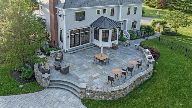 5 Carolina Way, Boxford, MA 01921 - rear view of house featuring a sunroom, a patio area, a fenced backyard, and a chimney