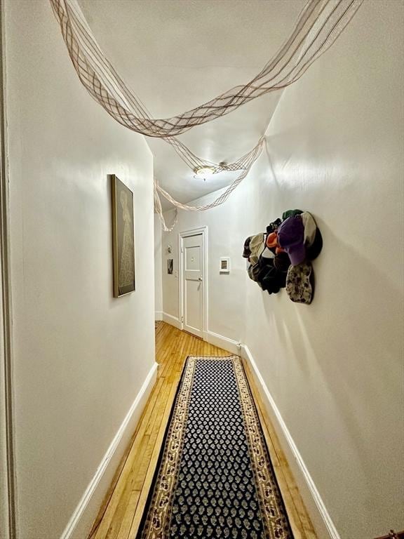 hall with light wood finished floors and baseboards