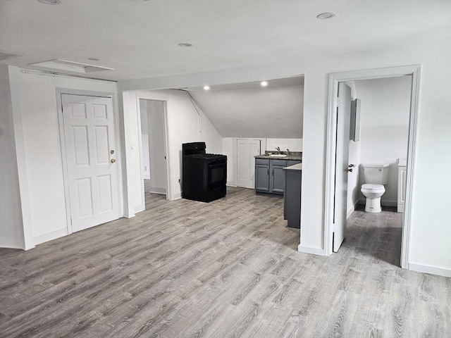 21 High St, South Hadley, MA 01075 - kitchen with black range with gas cooktop, light wood-style floors, vaulted ceiling, recessed lighting, and gray cabinets