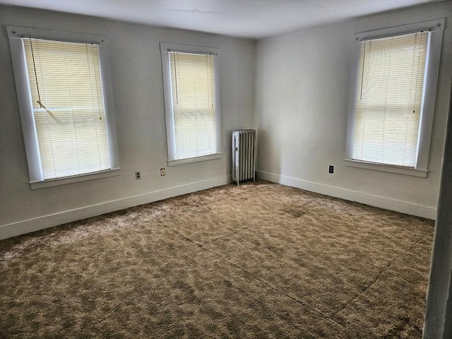 21 High St, South Hadley, MA 01075 - unfurnished room with radiator heating unit, carpet, and plenty of natural light