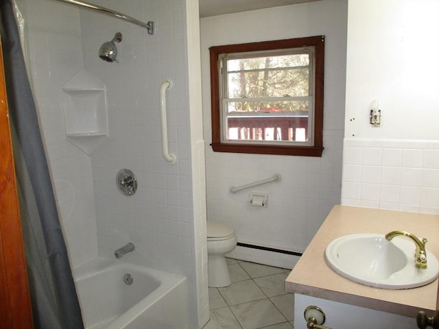 full bathroom featuring tile walls, vanity, baseboard heating, toilet, and tile patterned floors