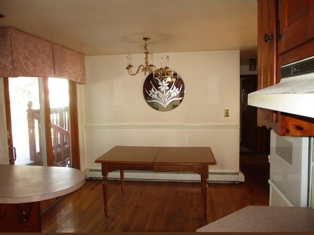 dining room with an inviting chandelier, baseboard heating, and dark wood-type flooring