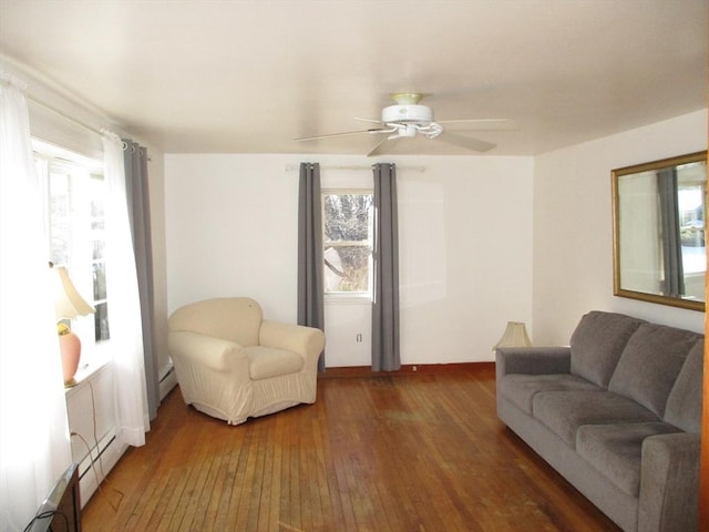 living room featuring ceiling fan, dark hardwood / wood-style floors, and a healthy amount of sunlight