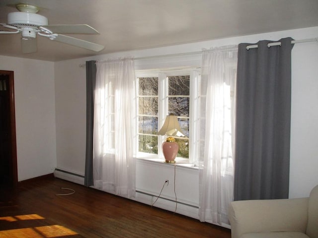 interior space with ceiling fan and dark hardwood / wood-style flooring