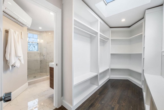 walk in closet featuring a wall mounted air conditioner and a skylight