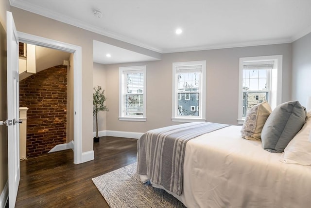 bedroom featuring dark hardwood / wood-style floors, multiple windows, and ornamental molding