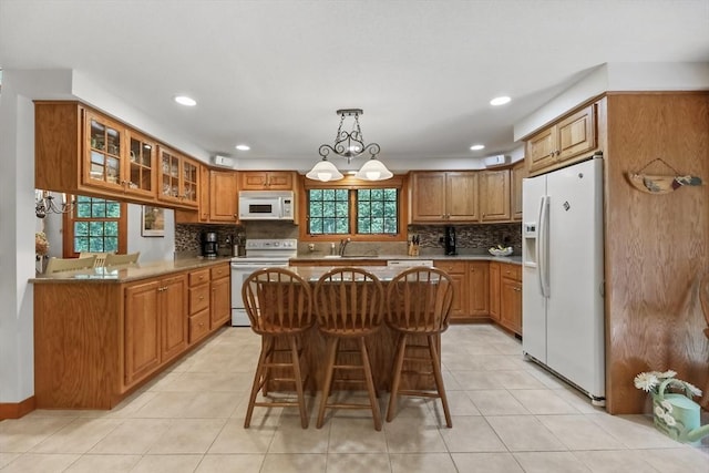236 Ridge Ave, Otis, MA 01253 - kitchen featuring white appliances, brown cabinetry, a sink, backsplash, and recessed lighting