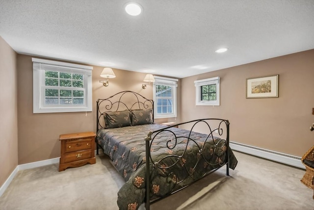 236 Ridge Ave, Otis, MA 01253 - carpeted bedroom with a baseboard radiator, multiple windows, baseboards, recessed lighting, and a textured ceiling