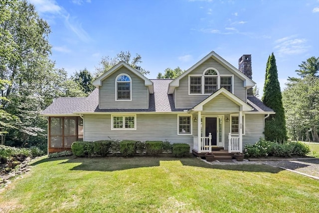 236 Ridge Ave, Otis, MA 01253 - view of front of property with a front lawn, a chimney, a sunroom, and roof with shingles